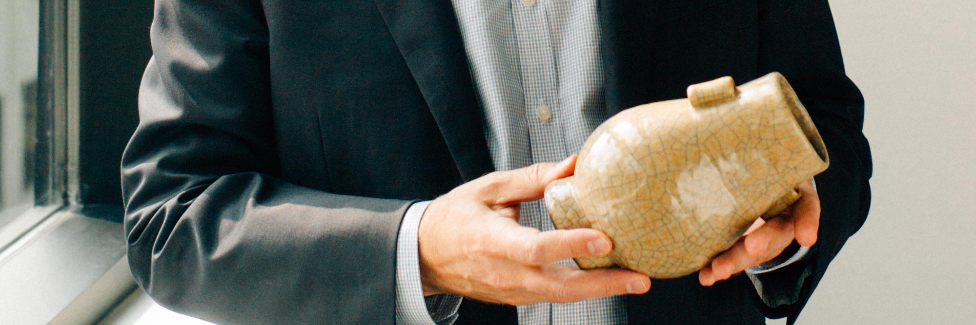 Freeman's appraiser examining an asian vase